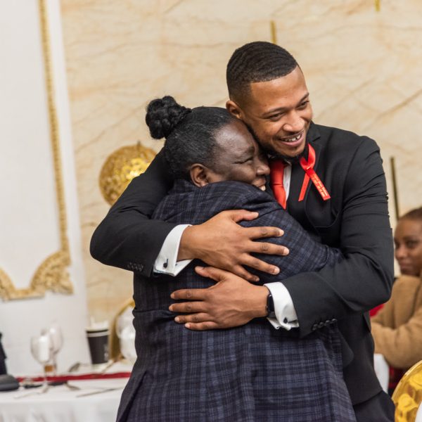 friends embrace at funeral wake